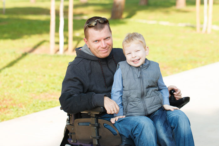 man with long term disability insurance with son at the park